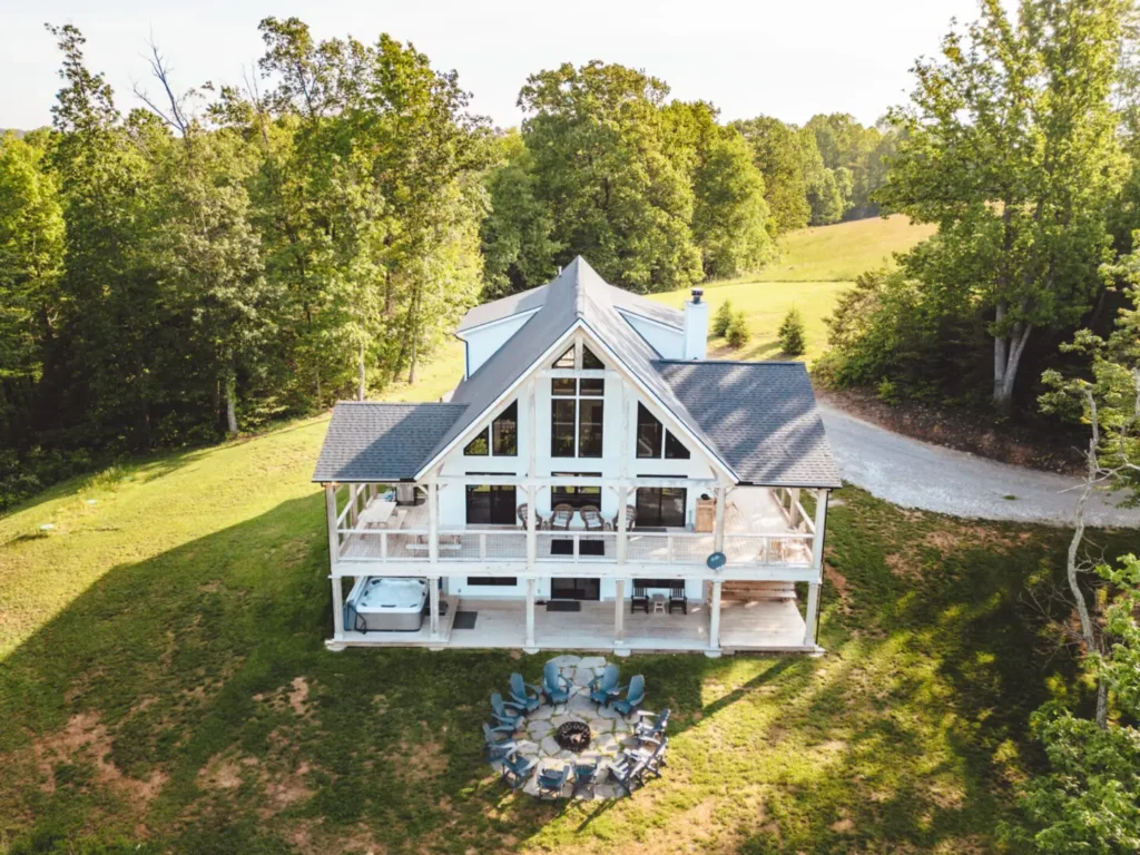Aerial view of white cabin with firepit