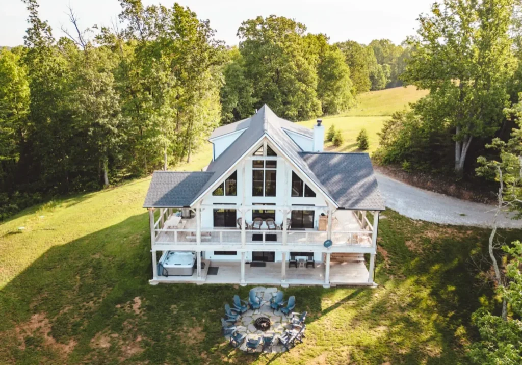 Aerial view of white cabin with firepit